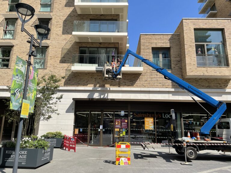 Men doing balcony repairs using MEWP equipment